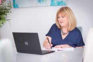 Sarah using laptop at desk